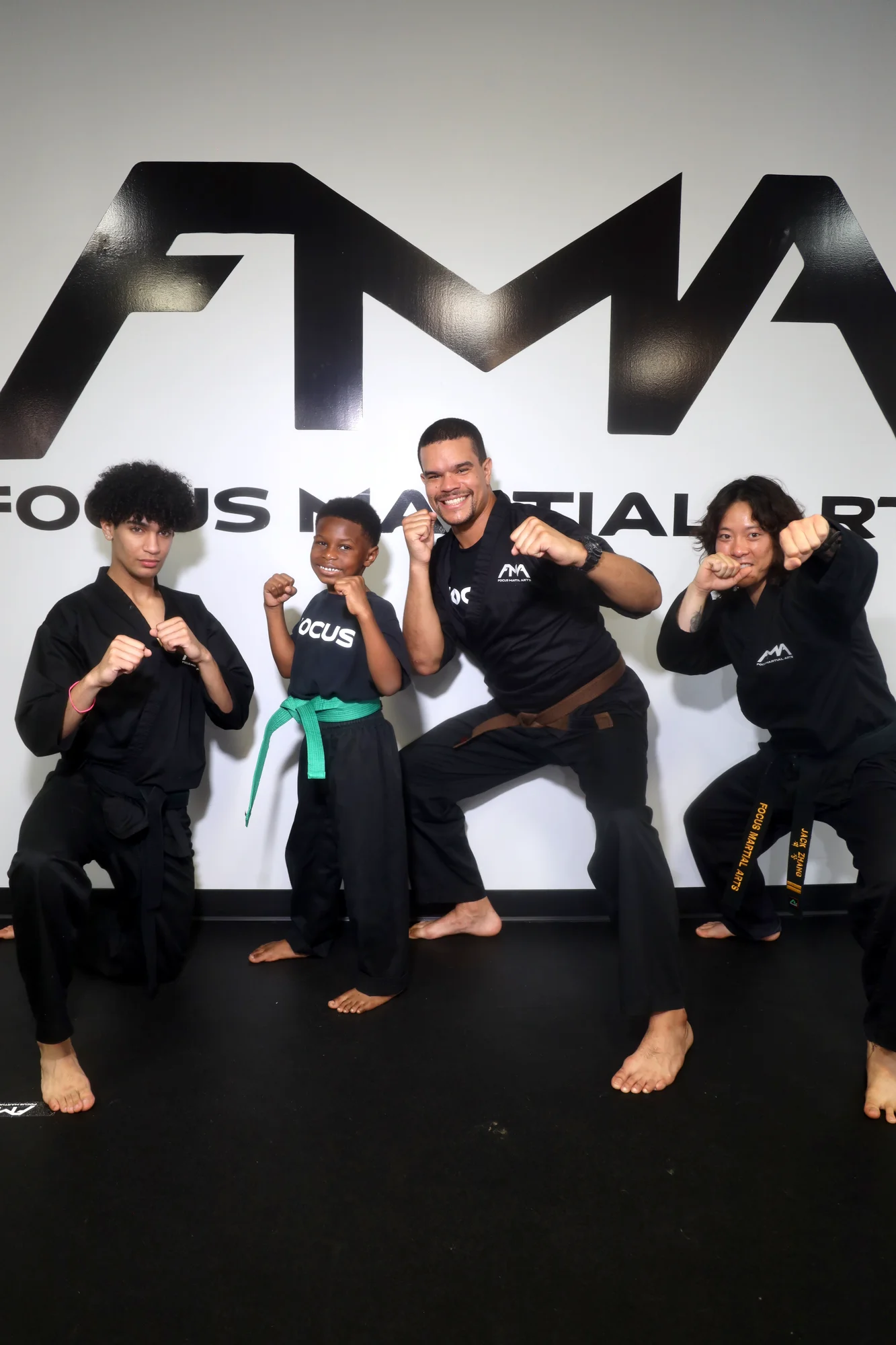 Group of teen martial arts students and an instructor posing