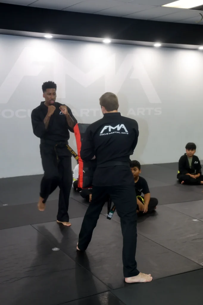 Focus Martial Arts Instructor and student practicing a kicking technique