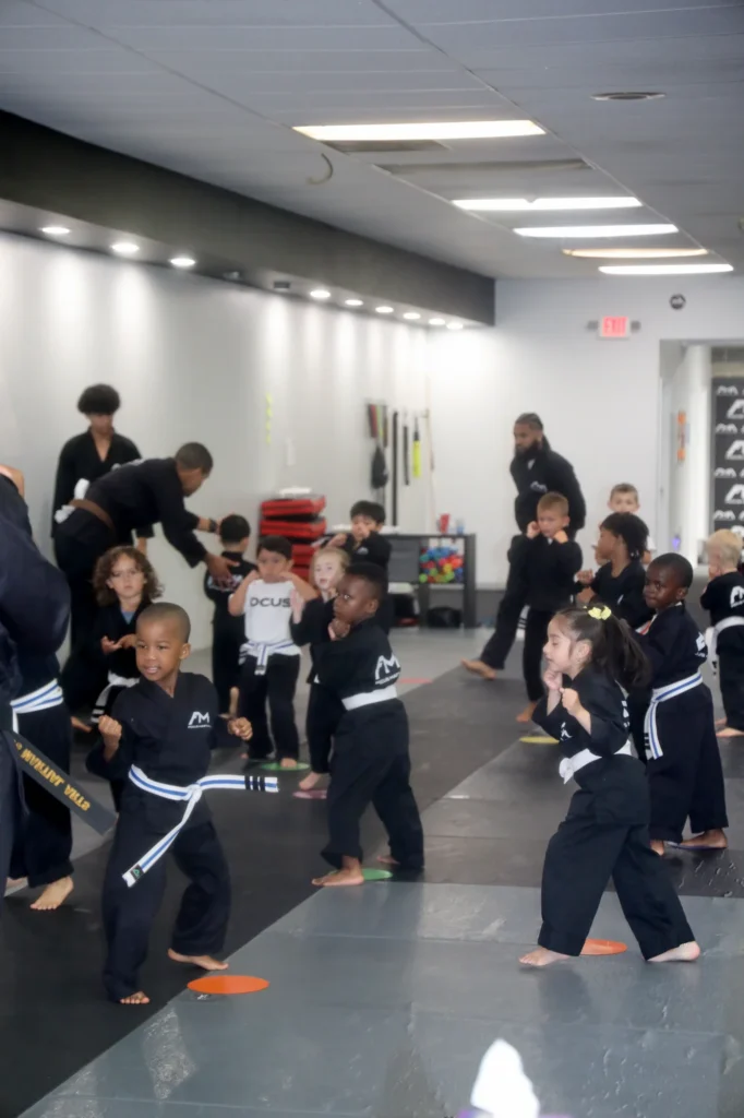 Focus Martial Arts Instructors leading a line of kids students through a