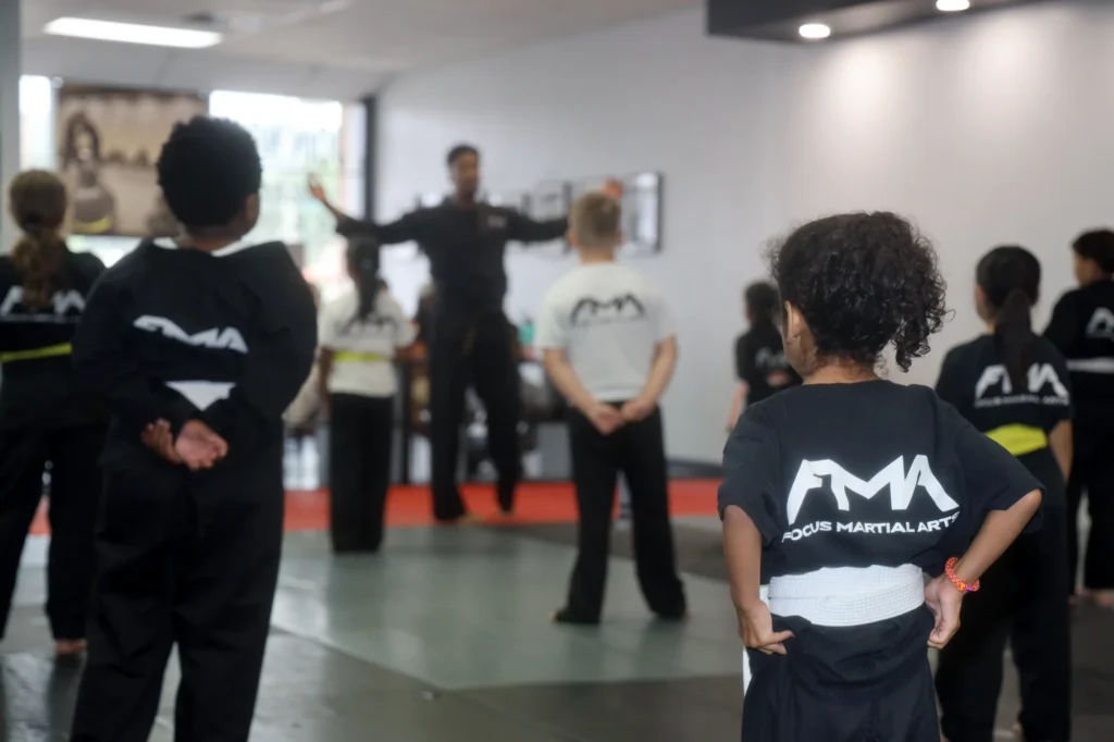 Focus Martial Arts instructor demonstrating a technique in front of a line of 2