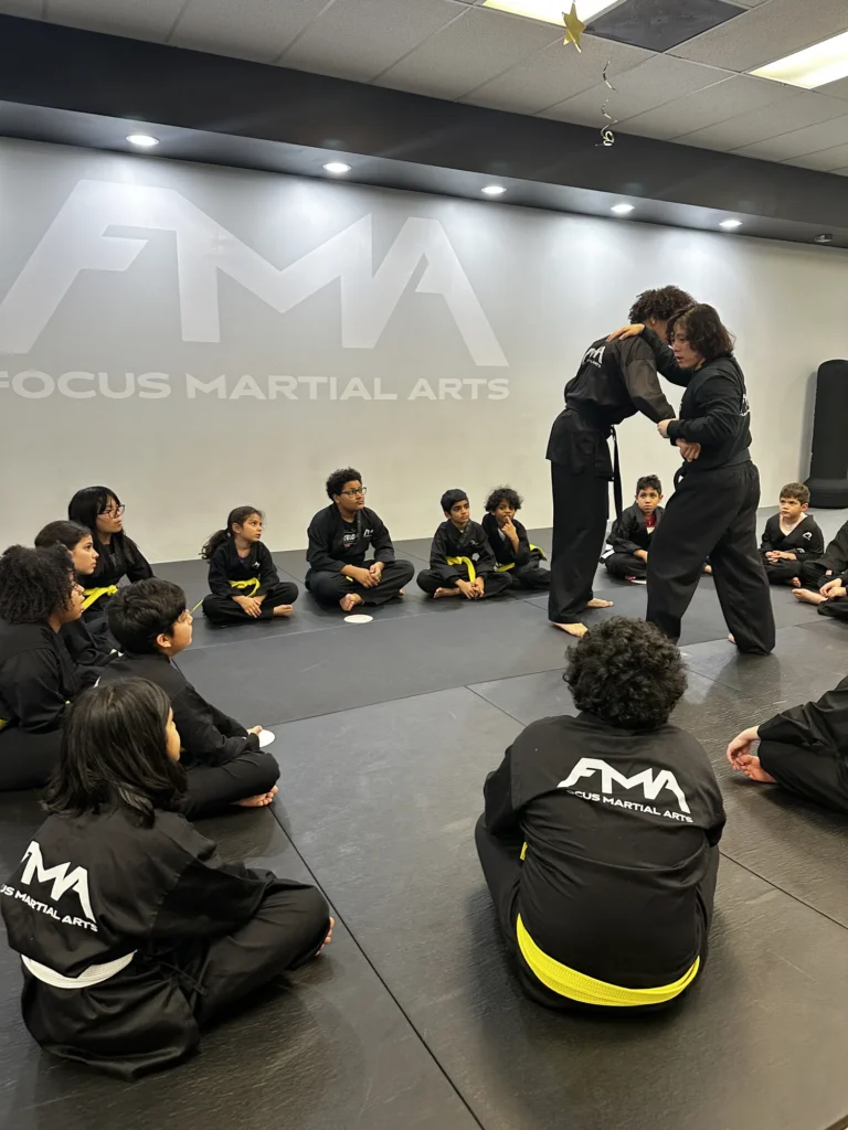 Focus Martial Arts instructor demonstrating a technique in front of a line of