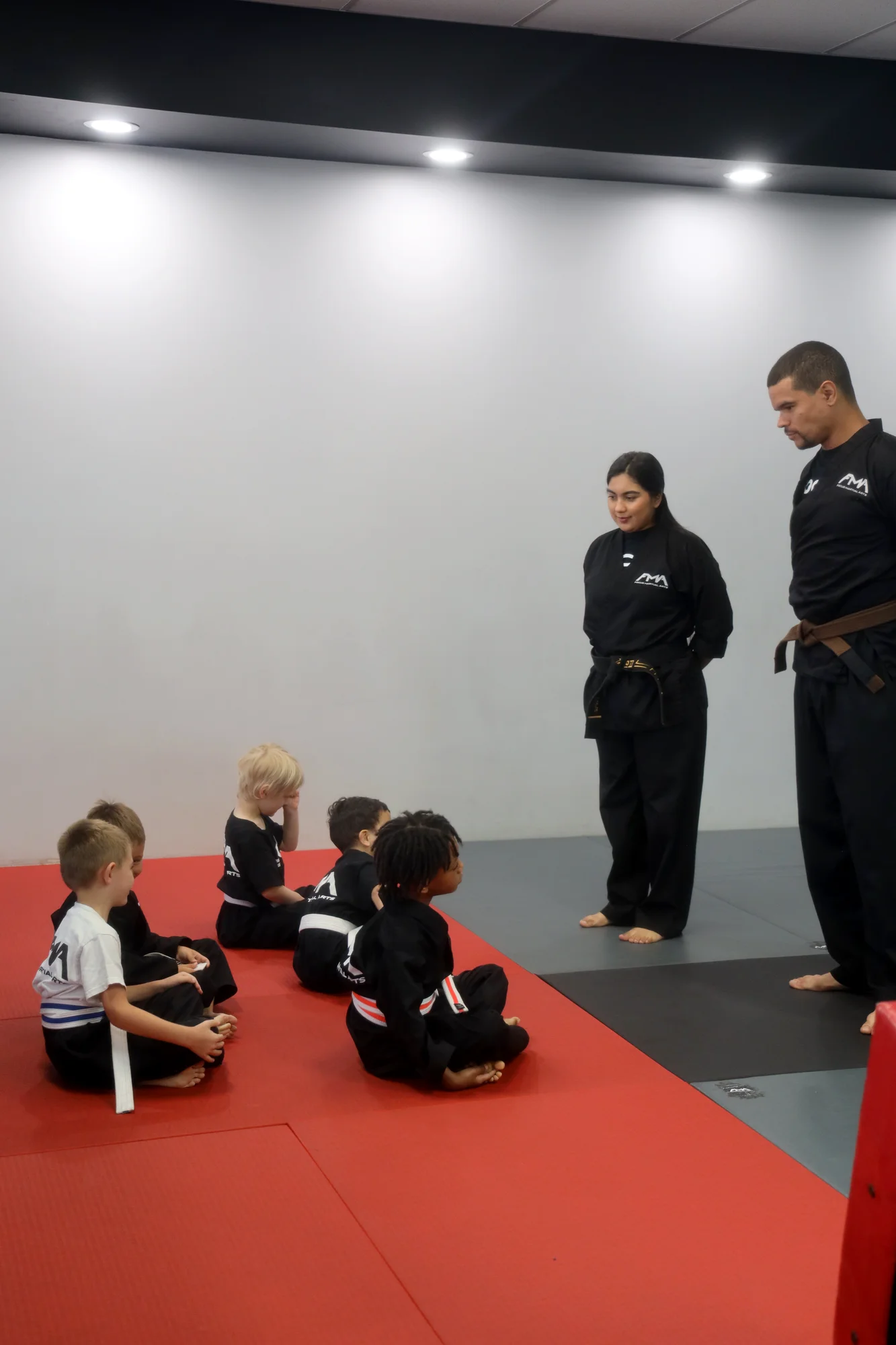 Focus Martial Arts instructor working one-on-one with students on the studio mat
